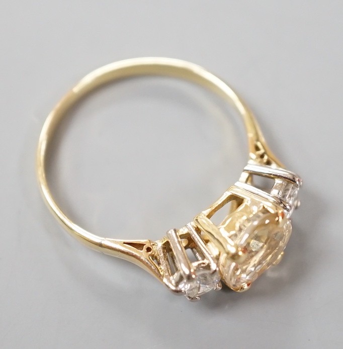 A yellow metal, singe stone oval cut yellow sapphire and two stone round cut diamond set ring, size N/O, gross weight 2.9 grams.